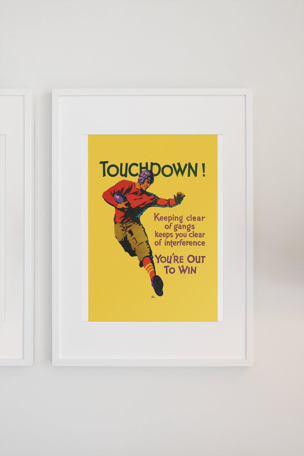 Touchdown poster in a white frame on a light wall