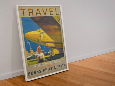 Travel Air Land Sea Burns Philp poster in a white frame leaning against a wall