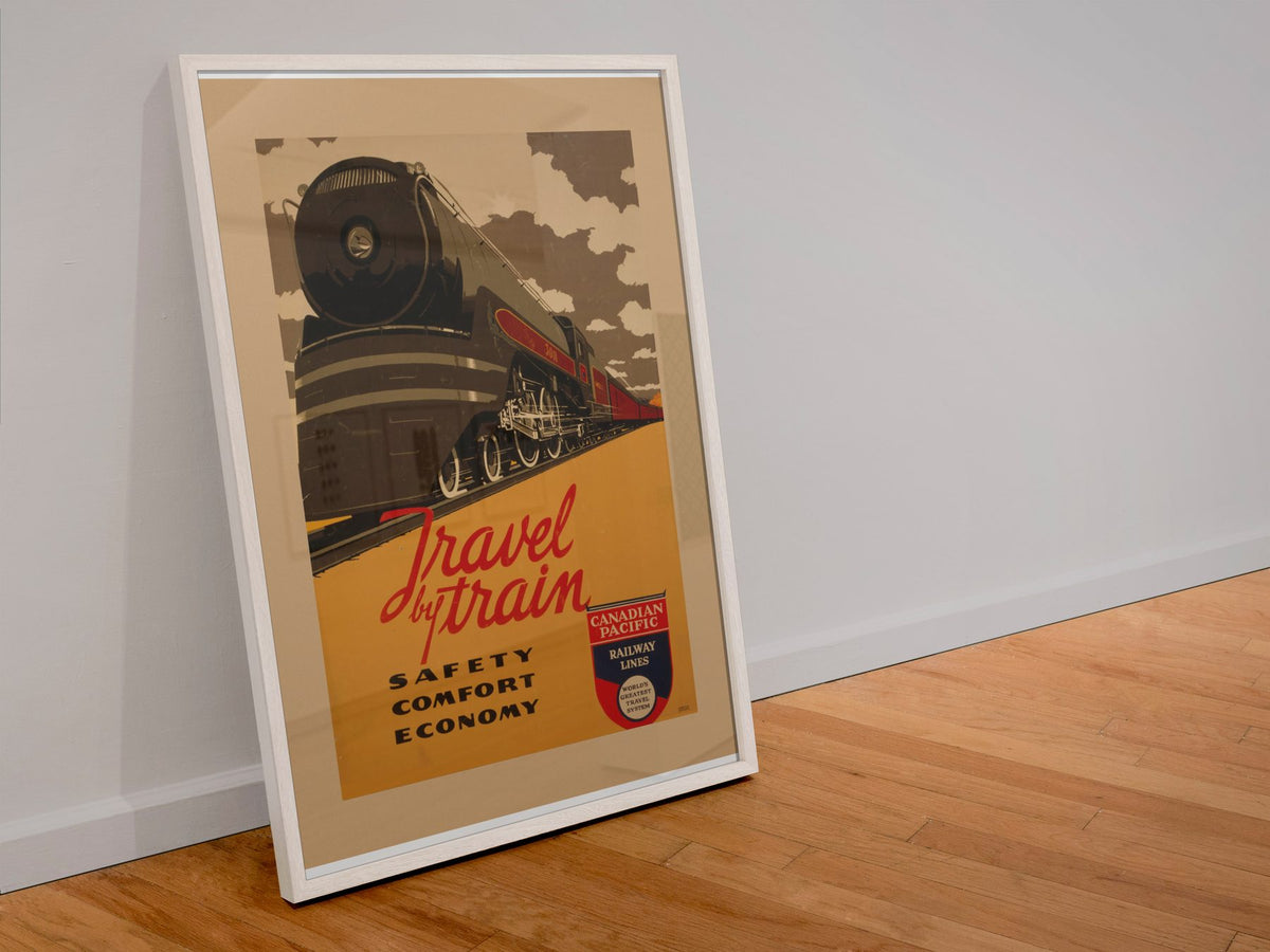 Travel by Train Canadian Pacific poster in a white frame leaning against a wall