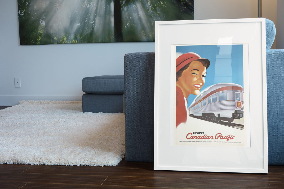 Travel Canadian Pacific 1948 poster leaning beside a blue sofa