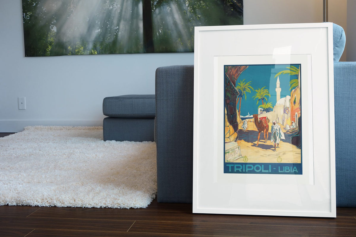 Tripoli Libia poster leaning beside a blue sofa