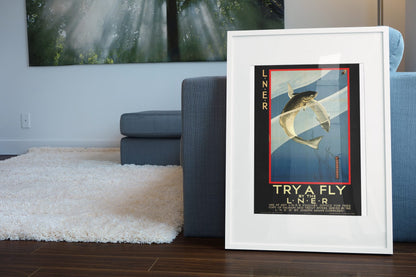 Try a Fly LNER Trout Fishing poster leaning beside a blue sofa