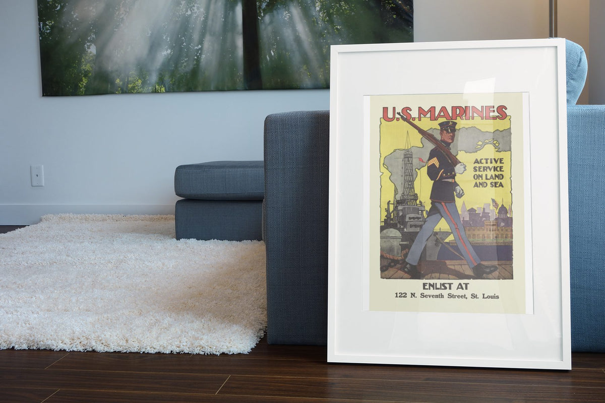 US Marines Active Service on Land and Sea poster leaning beside a blue sofa