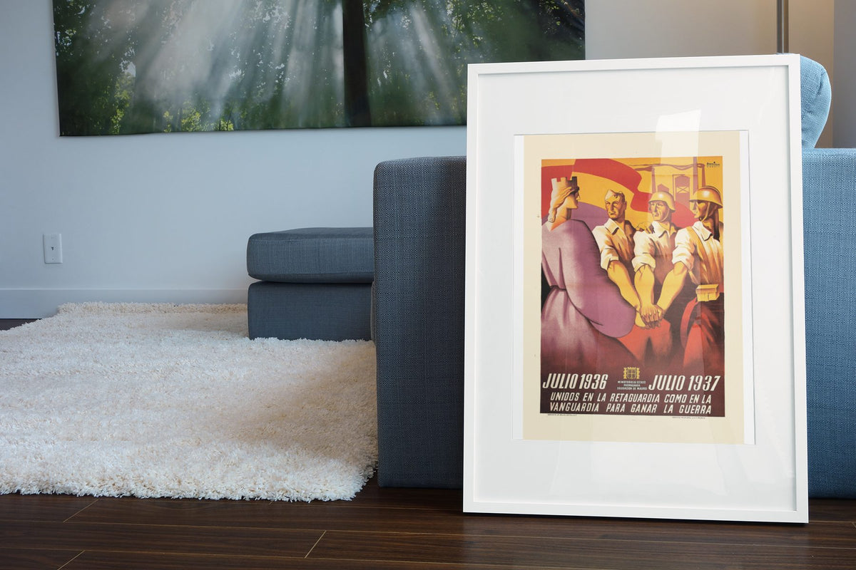 United July 1936 July 1937 poster leaning beside a blue sofa