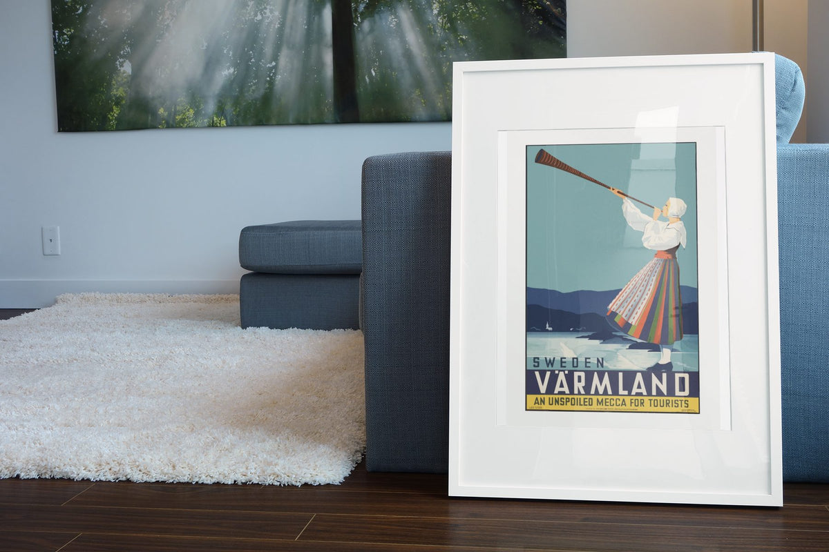 Varmland Sweden poster leaning beside a blue sofa