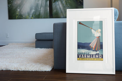 Varmland Sweden poster leaning beside a blue sofa