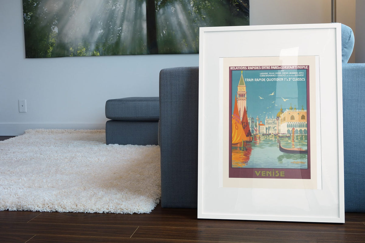 Venise Paris to Constantinople Express poster leaning beside a blue sofa