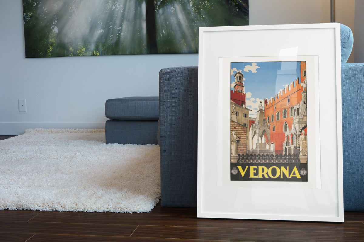Verona Italy 1938 poster leaning beside a blue sofa