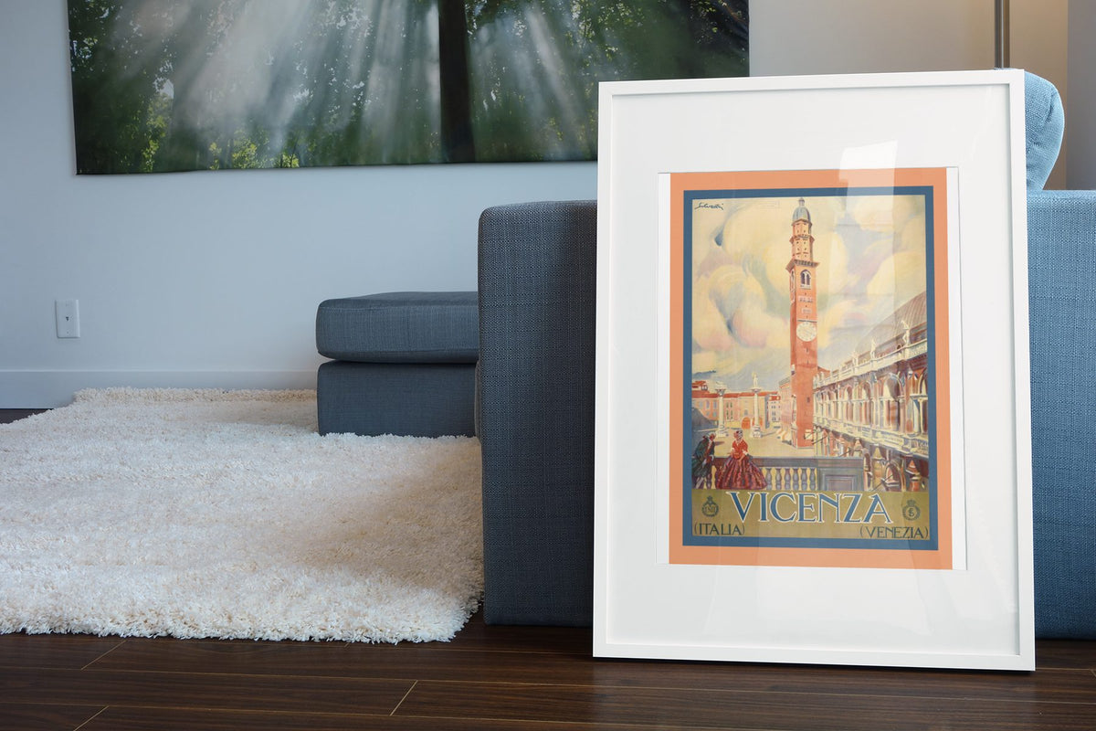 Vicenza Basilica Palladiana poster leaning beside a blue sofa