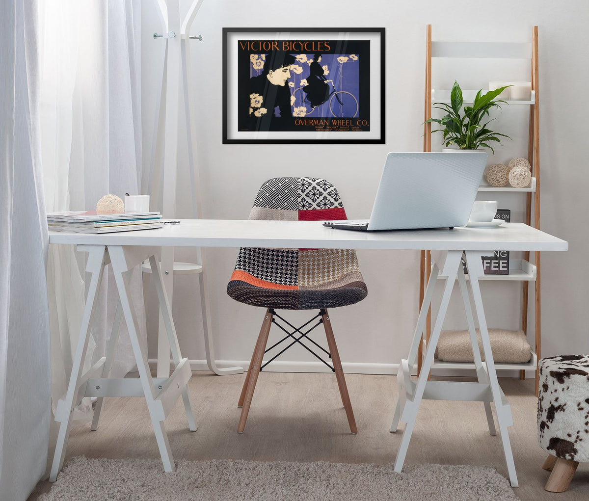 Victor Bicycles poster framed above a white desk in a home office