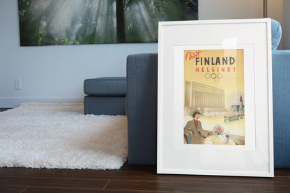 Visit Finland Helsinki poster leaning beside a blue sofa
