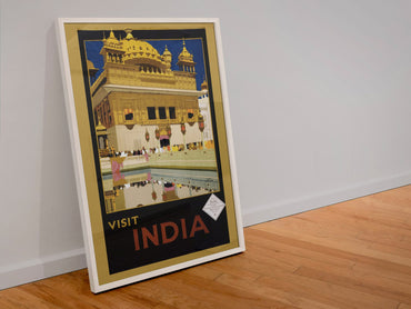 Visit India Golden Temple poster in a white frame leaning against a wall