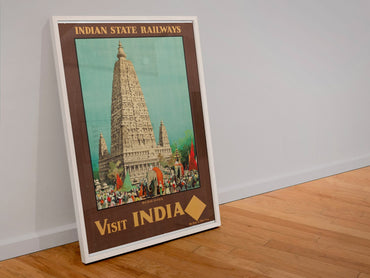Visit India Indian State Railways poster in a white frame leaning against a wall