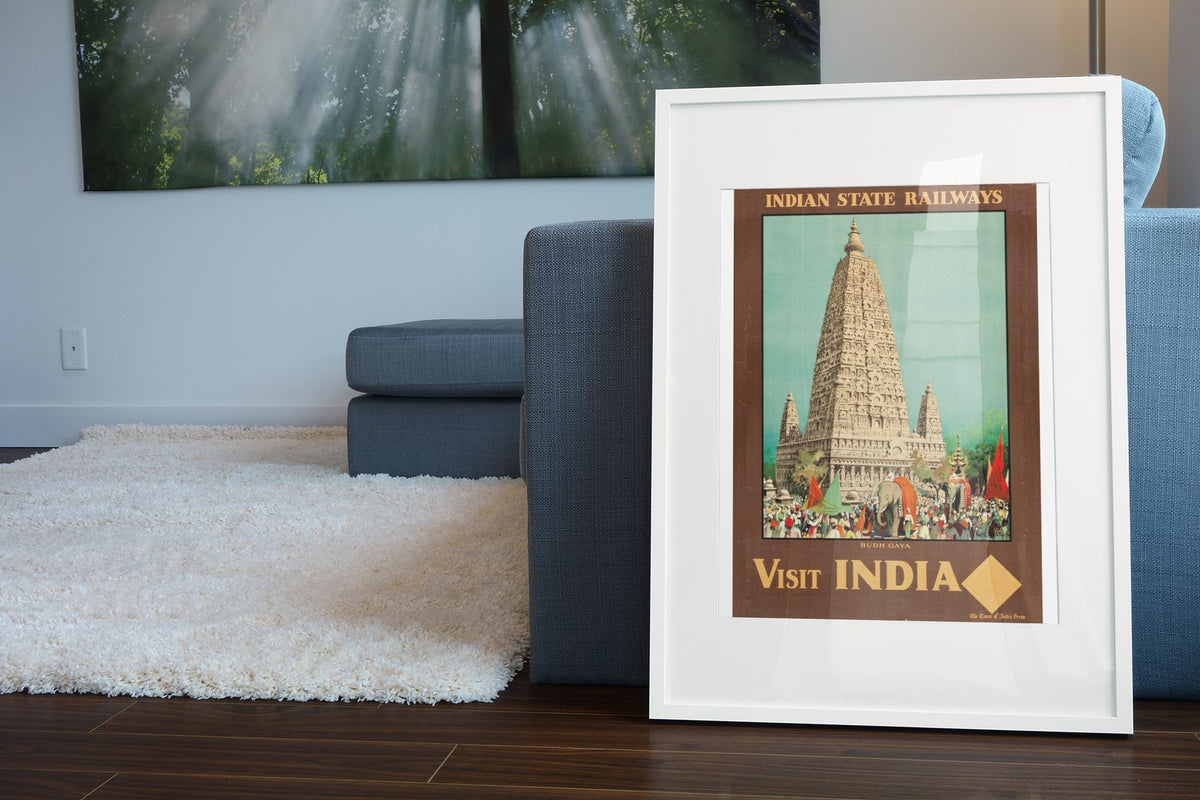 Visit India Indian State Railways poster leaning beside a blue sofa