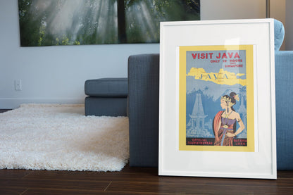 Visit Java poster leaning beside a blue sofa
