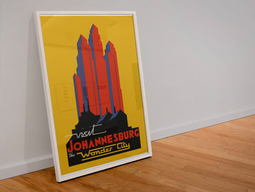 Visit Johannesburg poster in a white frame leaning against a wall