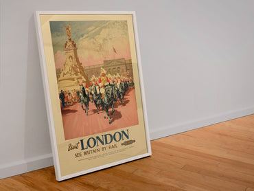 Visit London Coronation 1953 poster in a white frame leaning against a wall