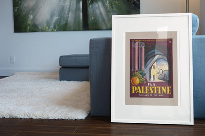 Visit Palestine Land of the Bible poster leaning beside a blue sofa