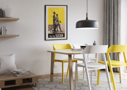 Visit the Sudan poster framed above a dining table