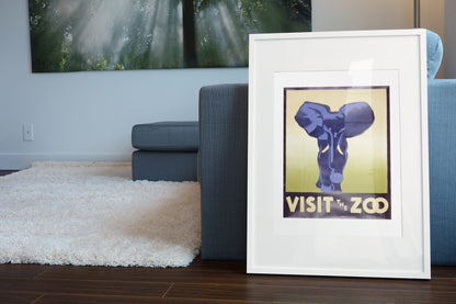 Visit the Zoo Elephant poster leaning beside a blue sofa