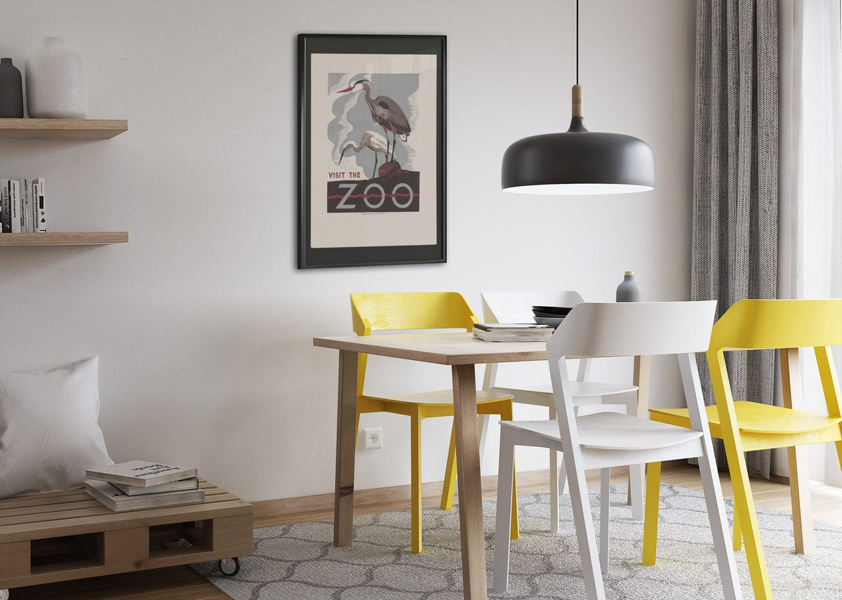 Visit the Zoo Herons poster framed above a dining table