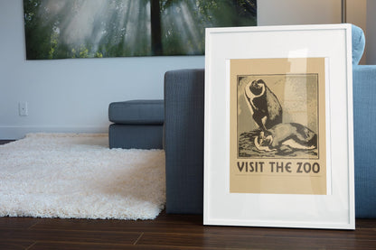 Visit the Zoo Penguin poster leaning beside a blue sofa