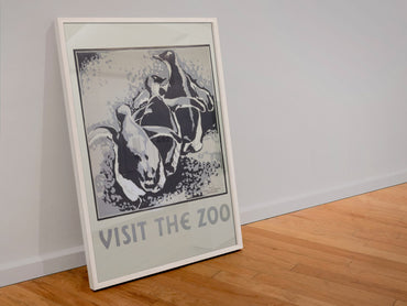 Visit the Zoo Penguins poster in a white frame leaning against a wall