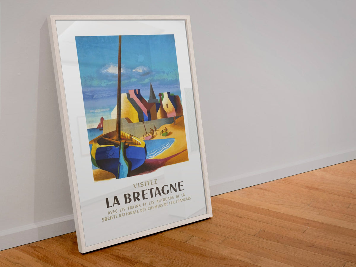 Visitez La Bretagne poster in a white frame leaning against a wall