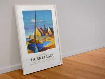Visitez La Bretagne poster in a white frame leaning against a wall