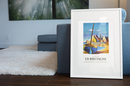 Visitez La Bretagne poster leaning beside a blue sofa