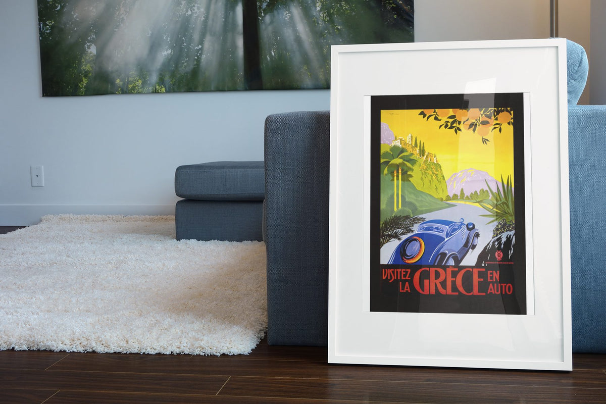 Visitez la Grece en Auto poster leaning beside a blue sofa