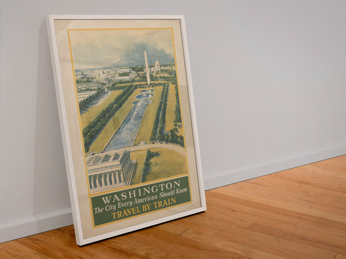 Washington Travel by Train poster in a white frame leaning against a wall