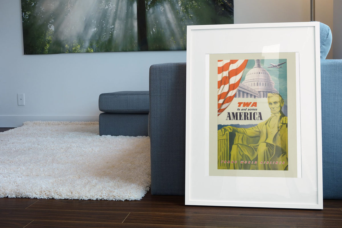 Washington TWA Across America poster leaning beside a blue sofa