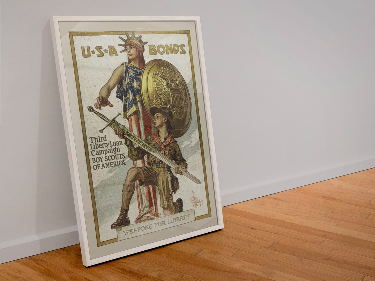 Weapons for Liberty Boy Scouts USA Bonds poster in a white frame leaning against a wall