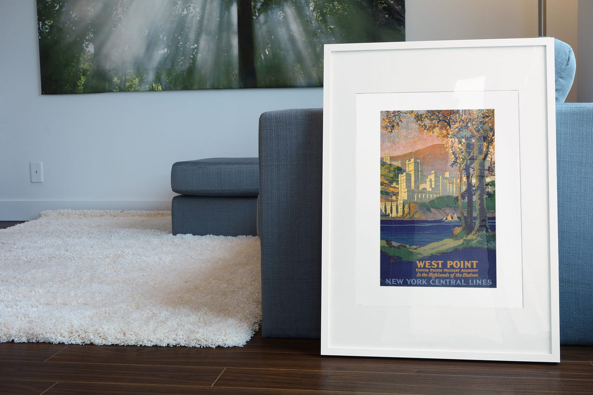 West Point New York Central poster leaning beside a blue sofa