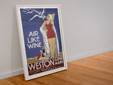 Weston super Mare Air Like Wine poster in a white frame leaning against a wall