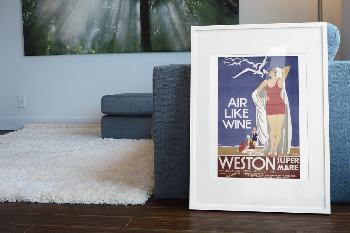 Weston super Mare Air Like Wine poster leaning beside a blue sofa