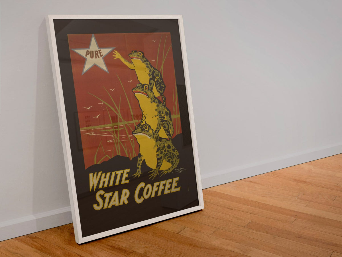 White Star Coffee Frogs poster in a white frame leaning against a wall