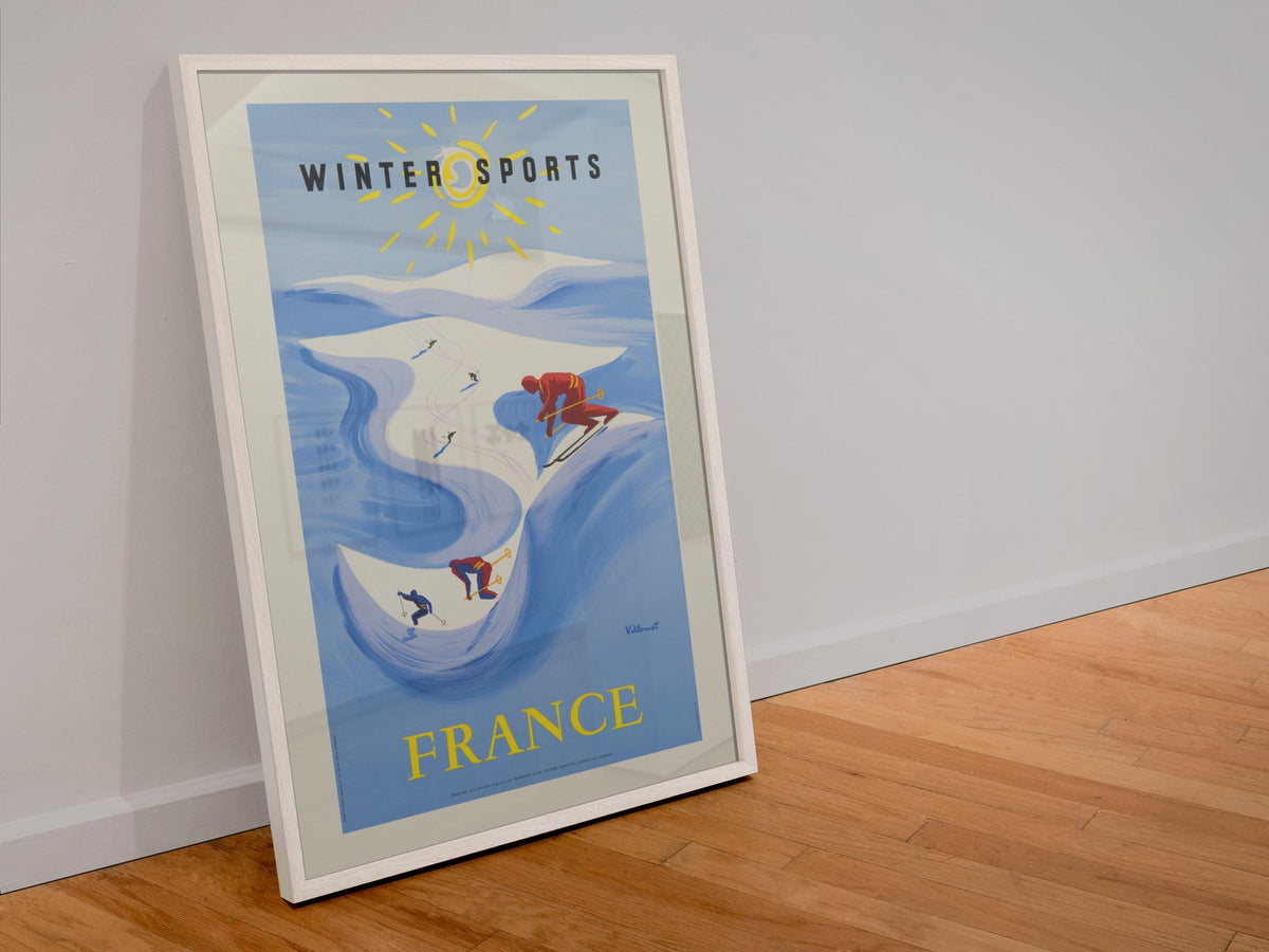 Winter Sports France poster in a white frame leaning against a wall