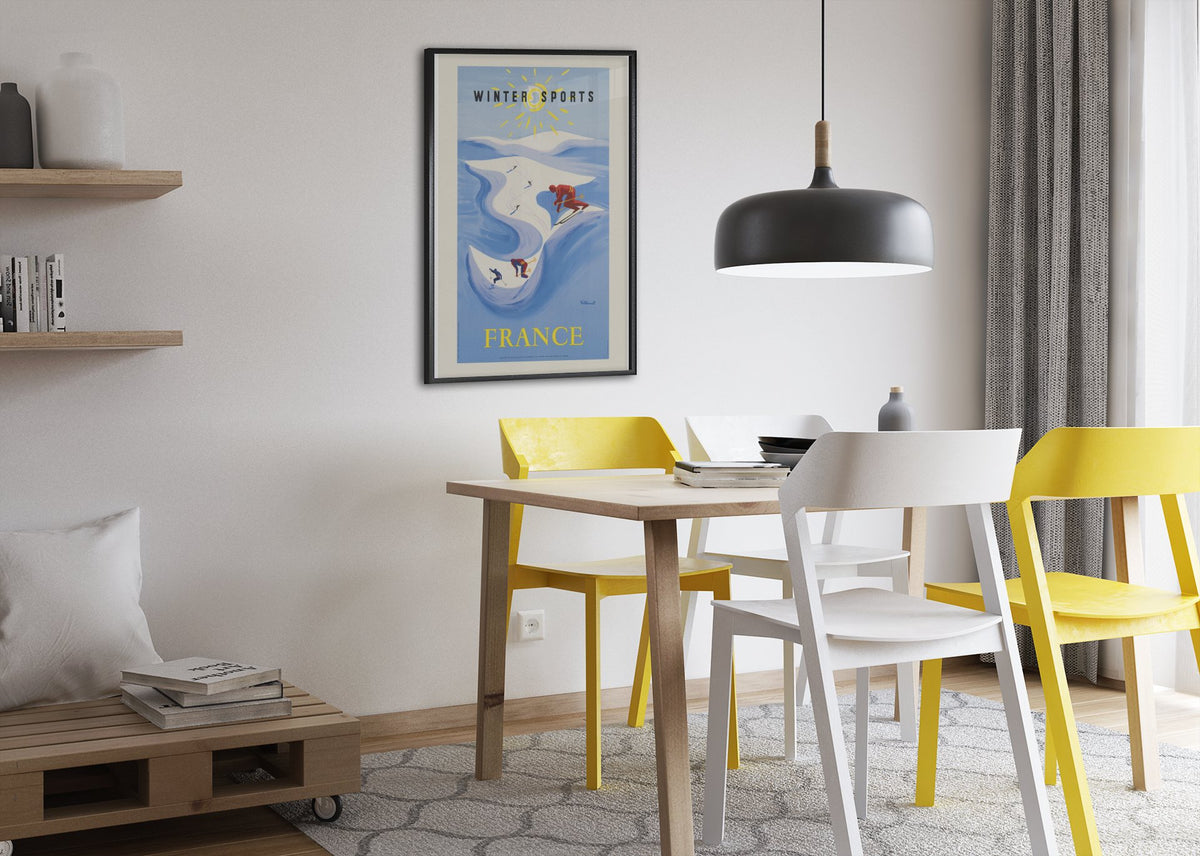 Winter Sports France poster framed above a dining table
