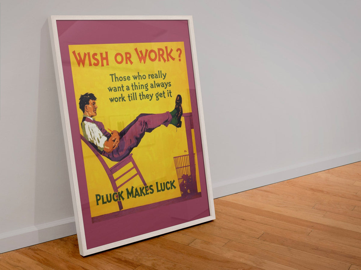 Wish or Work poster in a white frame leaning against a wall