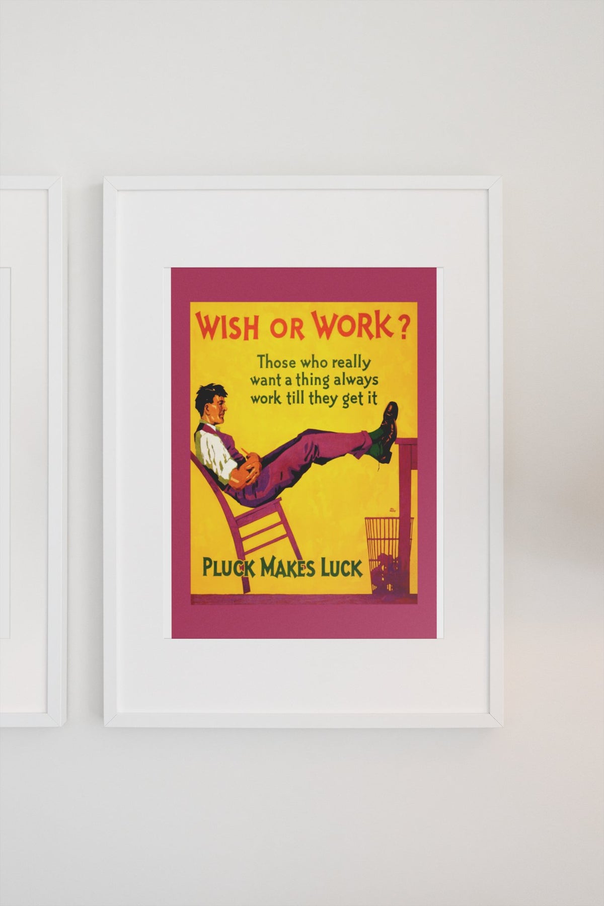 Wish or Work poster in a white frame on a light wall