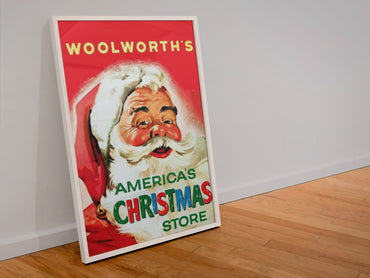 Woolworths Americas Christmas Store poster in a white frame leaning against a wall