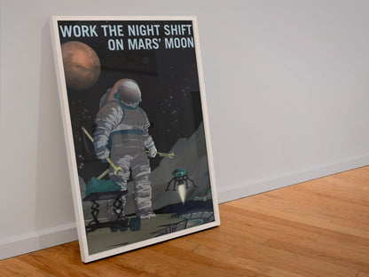 Work the Night Shift on Mars' Moon poster in a white frame leaning against a wall