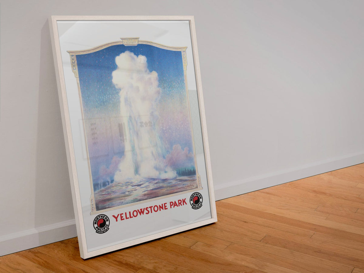 Yellowstone Old Faithful poster in a white frame leaning against a wall