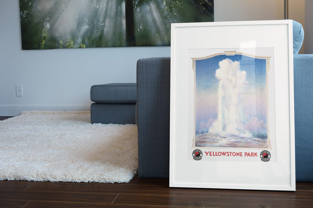 Yellowstone Old Faithful poster leaning beside a blue sofa