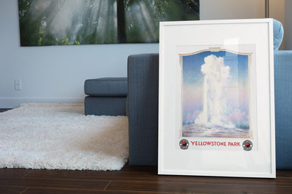 Yellowstone Old Faithful poster leaning beside a blue sofa