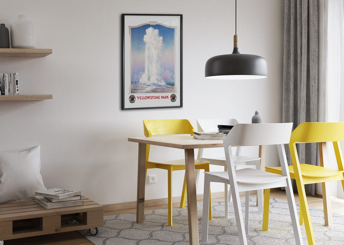 Yellowstone Old Faithful poster framed above a dining table