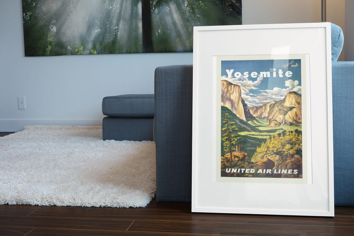 Yosemite United Air Lines poster leaning beside a blue sofa