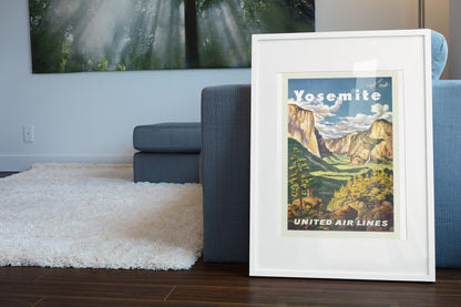 Yosemite United Air Lines poster leaning beside a blue sofa